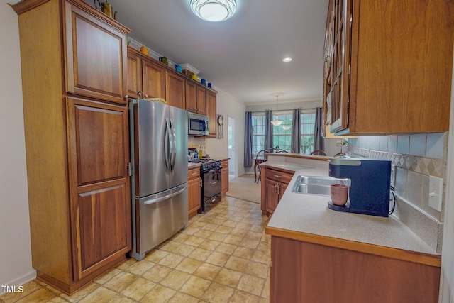 734 Crystal Forest Dr, Semora, NC 27343 - kitchen featuring appliances with stainless steel finishes, brown cabinetry, tasteful backsplash, light countertops, and recessed lighting