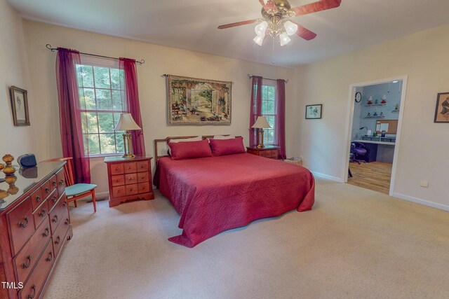 734 Crystal Forest Dr, Semora, NC 27343 - bedroom featuring multiple windows, light carpet, a ceiling fan, and ensuite bathroom