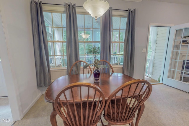 734 Crystal Forest Dr, Semora, NC 27343 - dining space featuring carpet flooring and plenty of natural light