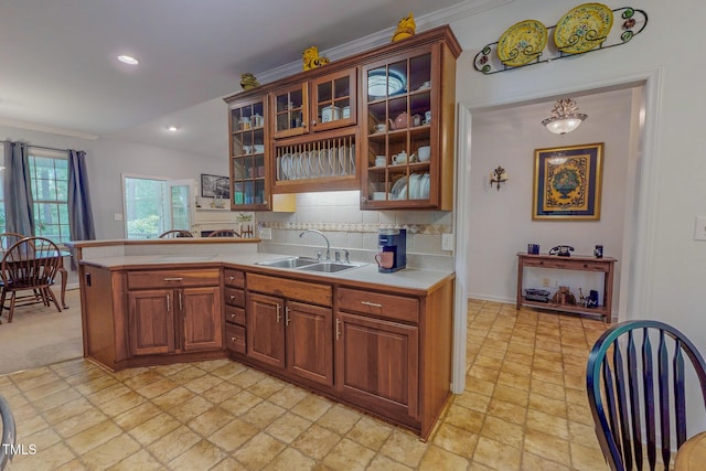 734 Crystal Forest Dr, Semora, NC 27343 - kitchen with light countertops, light stone finish floors, tasteful backsplash, brown cabinets, and recessed lighting