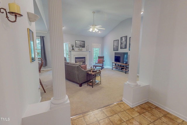 734 Crystal Forest Dr, Semora, NC 27343 - living room with a glass covered fireplace, light colored carpet, lofted ceiling, a ceiling fan, and decorative columns