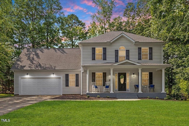 1990 Ferbow St, Creedmoor, NC 27522 - colonial-style house with a porch, concrete driveway, a garage, a front lawn, and a shingled roof