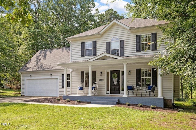1990 Ferbow St, Creedmoor, NC 27522 - view of front of home featuring covered porch, roof with shingles, an attached garage, and a front lawn