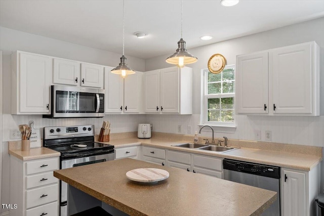 1990 Ferbow St, Creedmoor, NC 27522 - kitchen featuring stainless steel appliances, white cabinetry, decorative light fixtures, a kitchen island, and recessed lighting