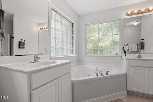 1990 Ferbow St, Creedmoor, NC 27522 - full bathroom with plenty of natural light, two vanities, and a jetted tub