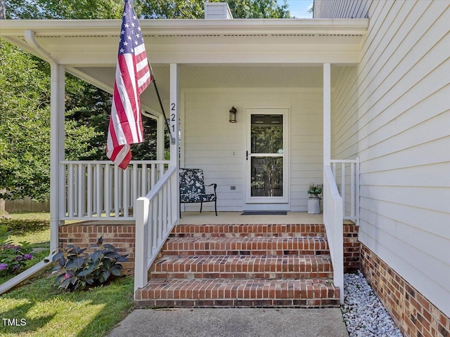 221 Antique Lace Way, Holly Springs, NC 27540 - doorway to property with covered porch and a chimney