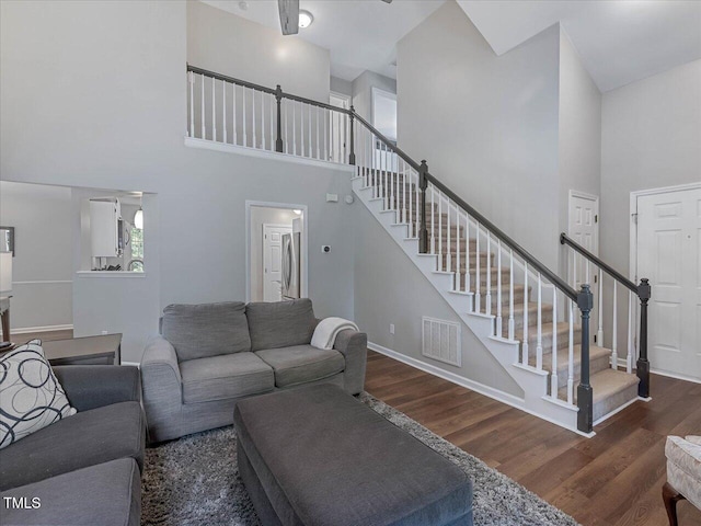 221 Antique Lace Way, Holly Springs, NC 27540 - living room with a high ceiling, stairway, and wood finished floors