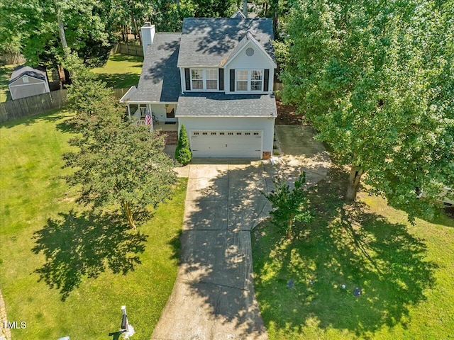 221 Antique Lace Way, Holly Springs, NC 27540 - view of front of home featuring concrete driveway, an attached garage, roof with shingles, and a chimney