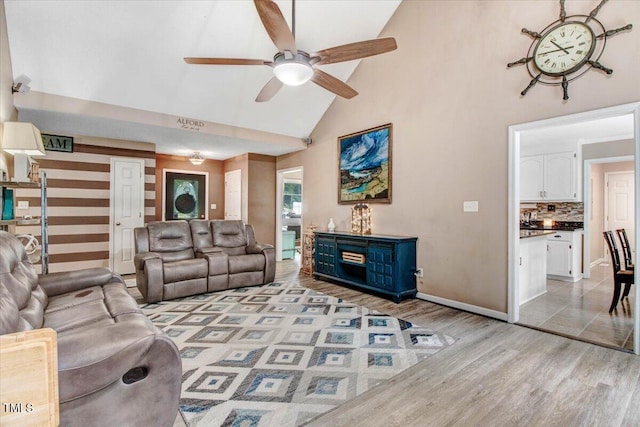 208 N Woodbridge Dr, Pikeville, NC 27863 - living area with high vaulted ceiling, ceiling fan, light wood finished floors, and baseboards