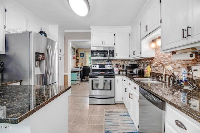 208 N Woodbridge Dr, Pikeville, NC 27863 - kitchen featuring stainless steel appliances, a sink, white cabinetry, dark stone counters, and decorative backsplash