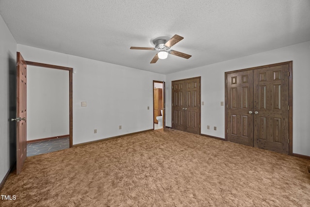 2382 Council Rd, Graham, NC 27253 - unfurnished bedroom featuring carpet flooring, multiple closets, a textured ceiling, ensuite bathroom, and ceiling fan