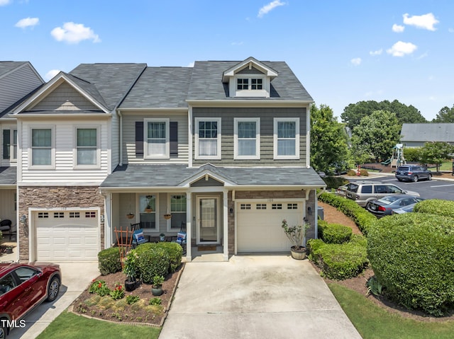 100 Beaconwood Ln, Holly Springs, NC 27540 - multi unit property featuring covered porch, concrete driveway, an attached garage, and stone siding