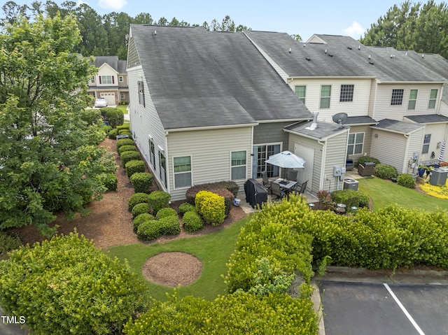 100 Beaconwood Ln, Holly Springs, NC 27540 - back of property with a shingled roof and a patio