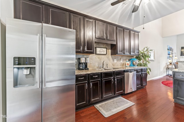100 Beaconwood Ln, Holly Springs, NC 27540 - kitchen featuring stainless steel appliances, dark wood finished floors, tasteful backsplash, light stone counters, and ceiling fan