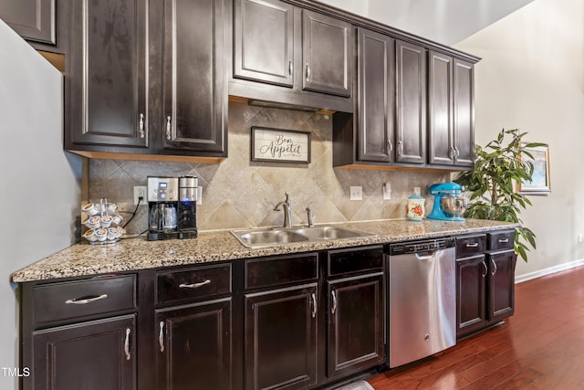 100 Beaconwood Ln, Holly Springs, NC 27540 - kitchen featuring stainless steel dishwasher, dark wood-type flooring, tasteful backsplash, and light stone countertops