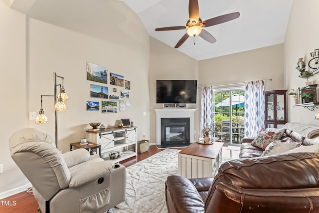 100 Beaconwood Ln, Holly Springs, NC 27540 - living room featuring wood finished floors, ceiling fan, a glass covered fireplace, and high vaulted ceiling