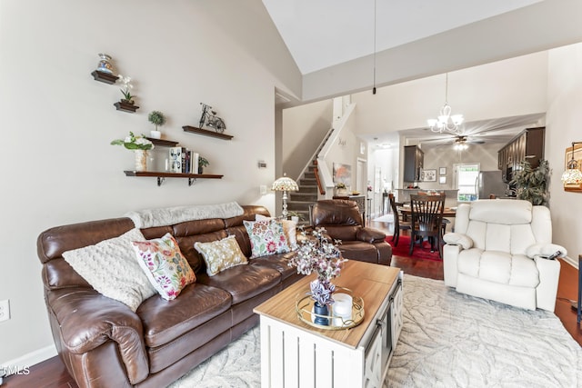 100 Beaconwood Ln, Holly Springs, NC 27540 - living area with stairway, light wood-style flooring, a chandelier, and high vaulted ceiling