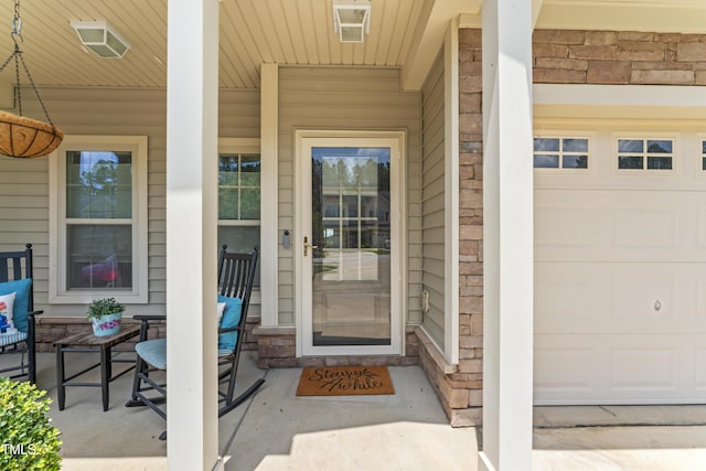 100 Beaconwood Ln, Holly Springs, NC 27540 - entrance to property featuring covered porch, stone siding, and a garage