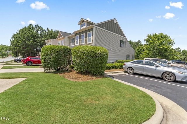 100 Beaconwood Ln, Holly Springs, NC 27540 - view of side of home featuring uncovered parking and a yard