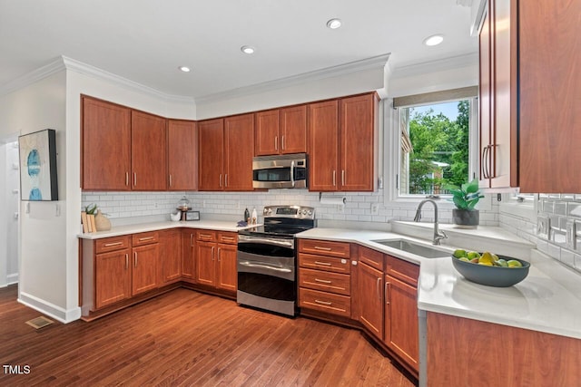 3 White Ash Dr, Durham, NC 27712 - kitchen with appliances with stainless steel finishes, light countertops, ornamental molding, backsplash, and recessed lighting