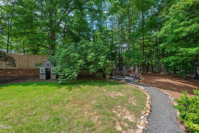 3 White Ash Dr, Durham, NC 27712 - view of yard with an outdoor fire pit, a storage unit, and a patio area