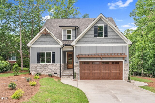 5504 Earle Rd, Raleigh, NC 27606 - craftsman inspired home with stone siding, roof with shingles, driveway, board and batten siding, and crawl space