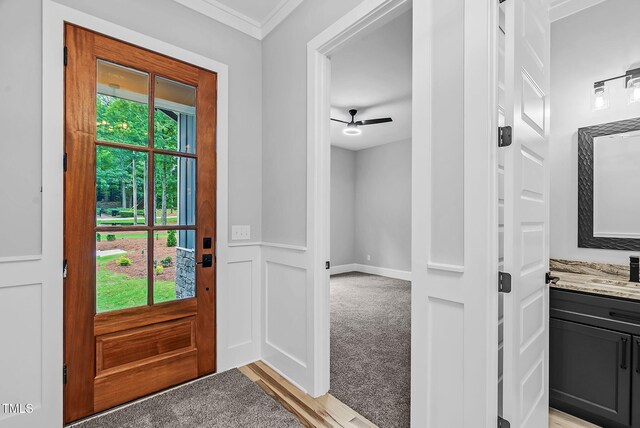5504 Earle Rd, Raleigh, NC 27606 - entryway with crown molding, light colored carpet, and ceiling fan