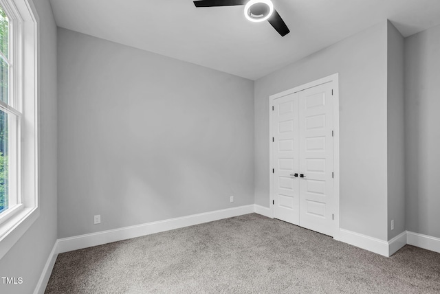 5504 Earle Rd, Raleigh, NC 27606 - unfurnished bedroom featuring carpet flooring, a closet, and a ceiling fan