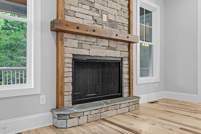 5504 Earle Rd, Raleigh, NC 27606 - detailed view of a stone fireplace and wood finished floors