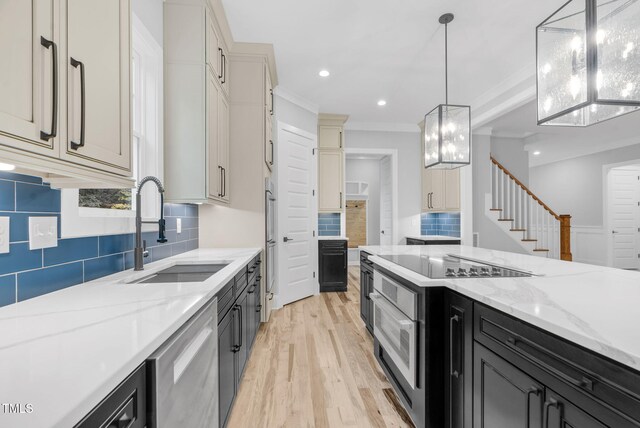 5504 Earle Rd, Raleigh, NC 27606 - kitchen featuring dishwasher, light wood-type flooring, tasteful backsplash, black electric cooktop, and dark cabinets