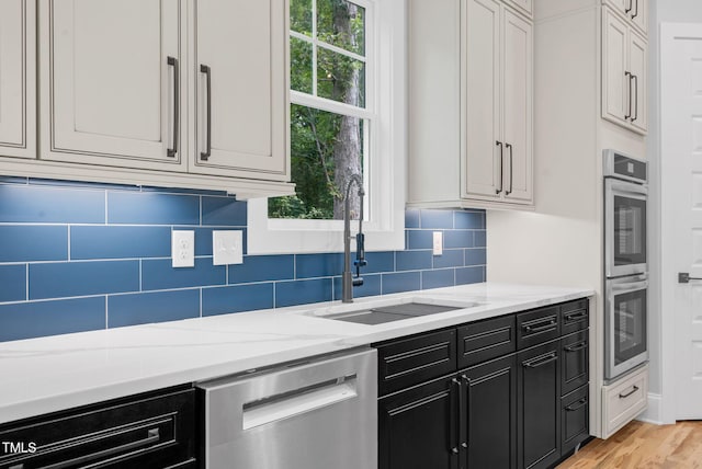 5504 Earle Rd, Raleigh, NC 27606 - kitchen with appliances with stainless steel finishes, healthy amount of natural light, decorative backsplash, and light stone countertops