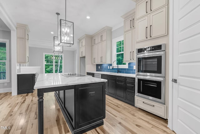 5504 Earle Rd, Raleigh, NC 27606 - kitchen featuring stainless steel double oven, tasteful backsplash, dark cabinetry, light wood-style flooring, and recessed lighting