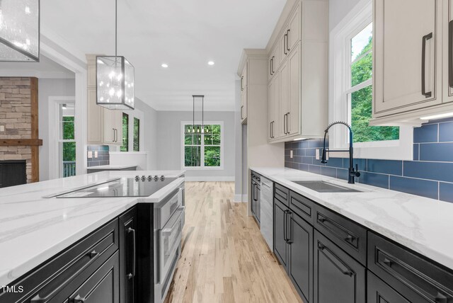 5504 Earle Rd, Raleigh, NC 27606 - kitchen featuring light wood-style flooring, black electric stovetop, light stone counters, tasteful backsplash, and recessed lighting