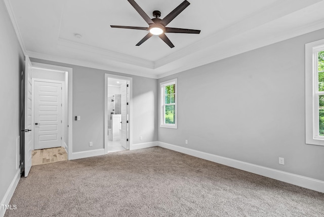 5504 Earle Rd, Raleigh, NC 27606 - unfurnished bedroom with carpet, crown molding, a raised ceiling, multiple windows, and ensuite bath