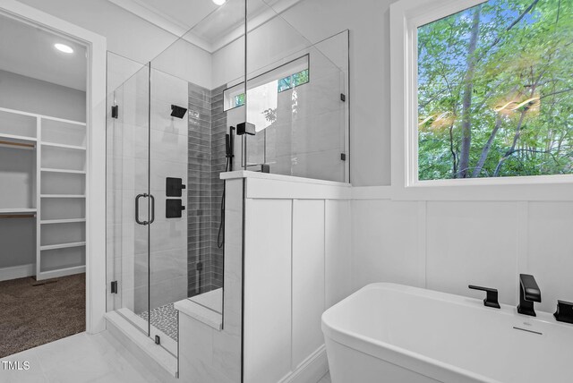 5504 Earle Rd, Raleigh, NC 27606 - full bath featuring a freestanding bath, a shower stall, a decorative wall, a spacious closet, and recessed lighting