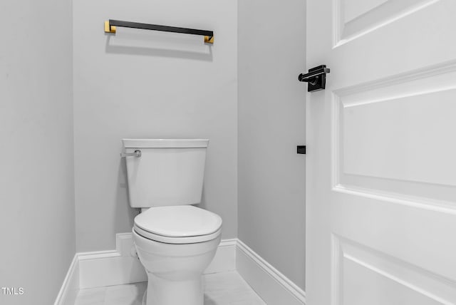 5504 Earle Rd, Raleigh, NC 27606 - bathroom featuring toilet and marble look tiles