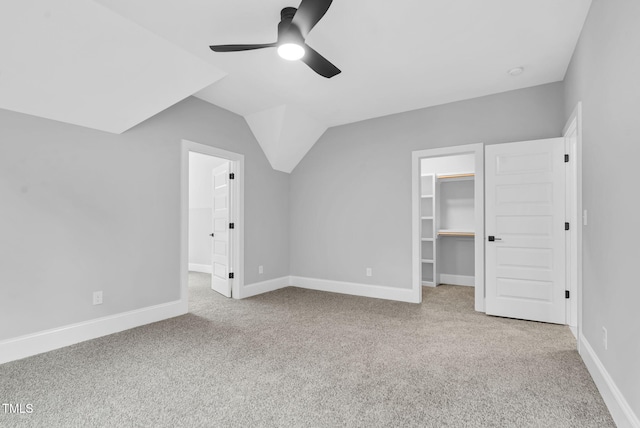 5504 Earle Rd, Raleigh, NC 27606 - unfurnished bedroom with a spacious closet, carpet flooring, a closet, vaulted ceiling, and a ceiling fan