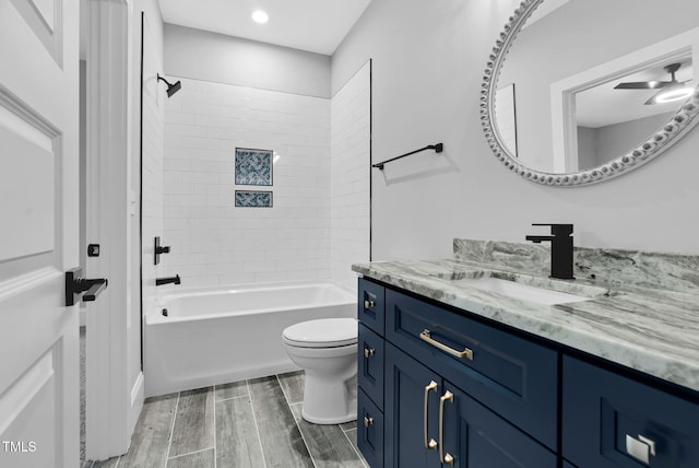 5504 Earle Rd, Raleigh, NC 27606 - bathroom with vanity, wood finished floors, washtub / shower combination, and recessed lighting