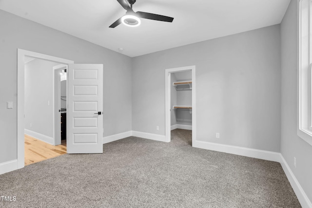 5504 Earle Rd, Raleigh, NC 27606 - unfurnished bedroom with carpet, a spacious closet, a closet, and ceiling fan