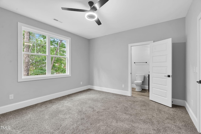 5504 Earle Rd, Raleigh, NC 27606 - unfurnished bedroom featuring carpet flooring, ensuite bath, and ceiling fan
