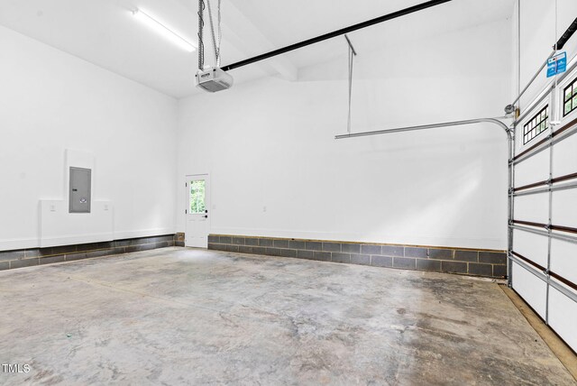 5504 Earle Rd, Raleigh, NC 27606 - garage featuring a garage door opener and electric panel
