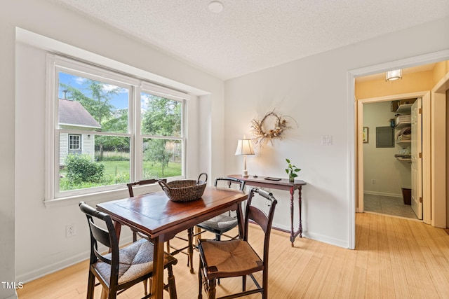 20 Timberlyne Rd, Chapel Hill, NC 27514 - dining room featuring healthy amount of natural light, light wood-style floors, a textured ceiling, and baseboards