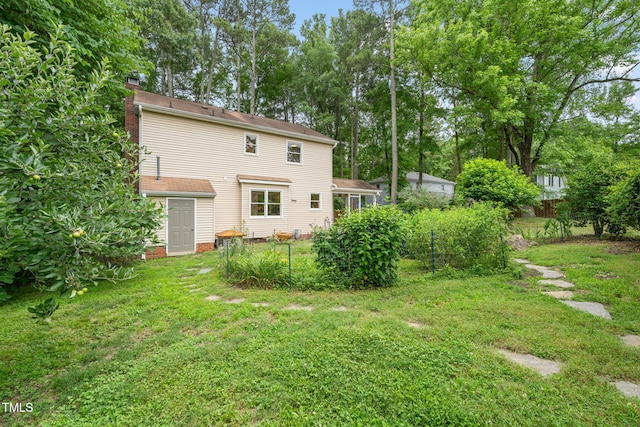 20 Timberlyne Rd, Chapel Hill, NC 27514 - rear view of house with a chimney and a yard