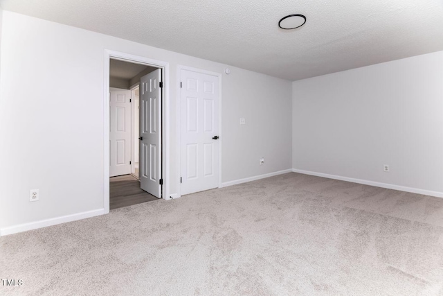404 Shannonford Ct, Wake Forest, NC 27587 - spare room featuring carpet floors, baseboards, and a textured ceiling