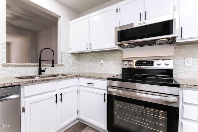 404 Shannonford Ct, Wake Forest, NC 27587 - kitchen with appliances with stainless steel finishes, a sink, tasteful backsplash, and white cabinets