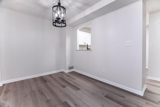 404 Shannonford Ct, Wake Forest, NC 27587 - unfurnished dining area with dark wood-type flooring, a chandelier, and baseboards