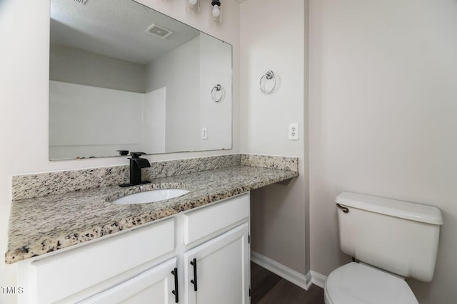 404 Shannonford Ct, Wake Forest, NC 27587 - bathroom featuring toilet, vanity, baseboards, and wood finished floors