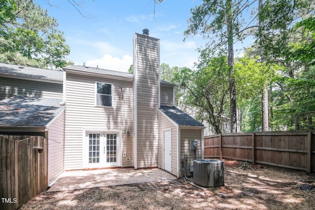 404 Shannonford Ct, Wake Forest, NC 27587 - rear view of house featuring central AC unit, a chimney, a patio, french doors, and a shingled roof