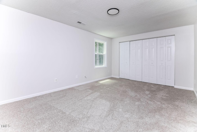 404 Shannonford Ct, Wake Forest, NC 27587 - unfurnished bedroom with carpet flooring, a textured ceiling, baseboards, and a closet