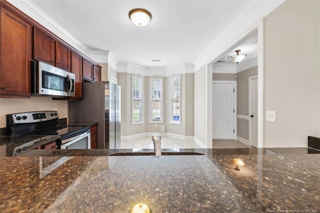 427 Georgetown Cir, Fayetteville, NC 28314 - kitchen featuring appliances with stainless steel finishes, crown molding, dark stone counters, a sink, and baseboards